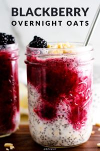 Jars of overnight oats on wood board with text that reads, "Blackberry Overnight Oats."