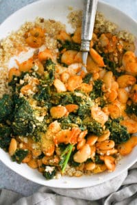 Butter Beans and Greens with quinoa in a white bowl.
