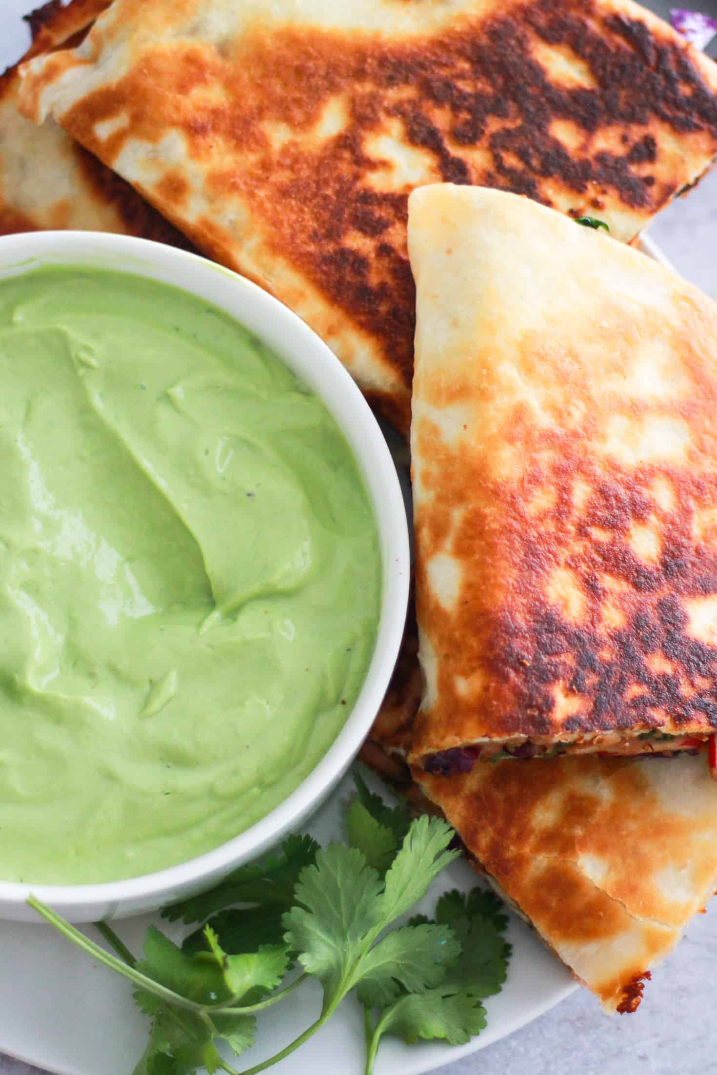 Overhead image of vegetarian quesadilla with avocado crema.