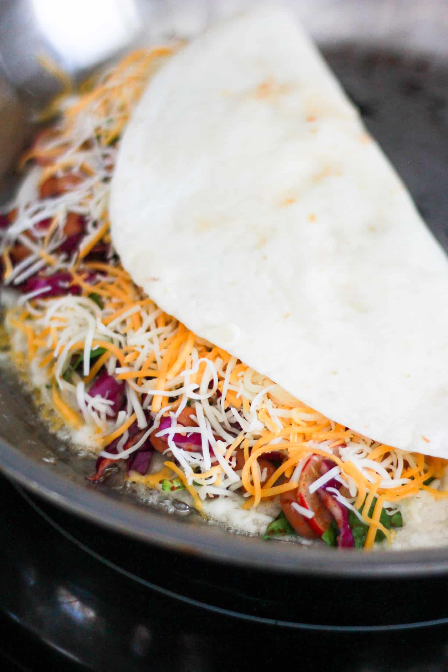 Cooking a quesadilla on a skillet.