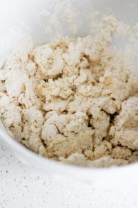 Whole wheat biscuit dough in a large white bowl.