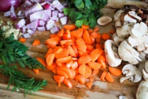 Chopped vegetables on a wood cutting board.