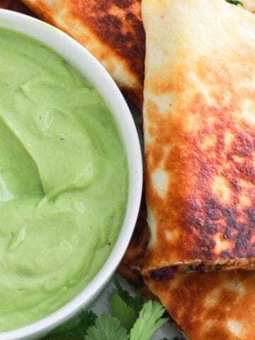 Vegetarian quesadilla served with avocado dipping sauce.