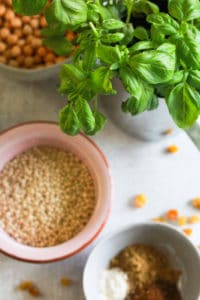 Fresh basil, dry couscous, chickpeas, and spices.