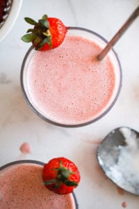 Vegan milkshakes in glasses with fresh strawberries.