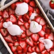 Vegan Strawberry Banana Baked Oatmeal topped with dollops of dairy-free yogurt alternative.