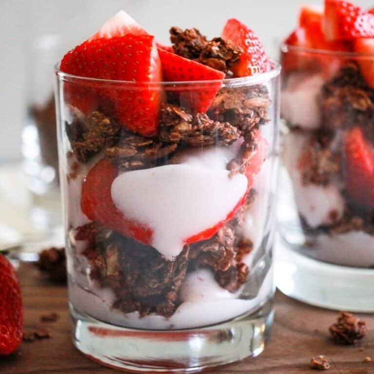 Strawberry yogurt parfait with fresh strawberries and chocolate granola.