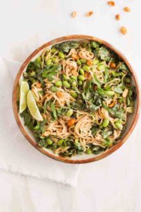 Peanut noodles in a brown ceramic dish with fresh lime for easy college meals