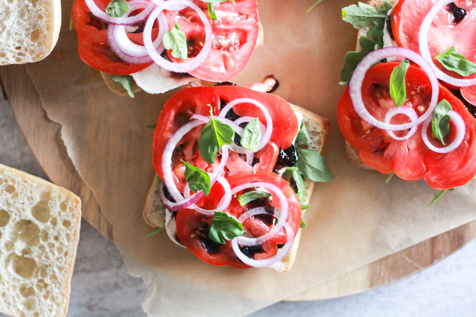 Open sandwiches with tomato, onion, and basil