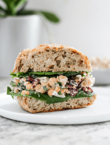 Chickpea salad sandwiches on a white plate as an example of easy college meals