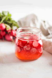 Glass jar with pickled radishes