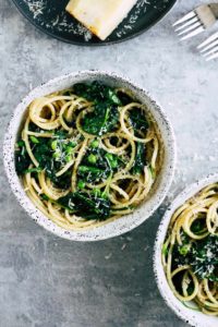 Pasta with cheese and greens in white bowls are easy college meals