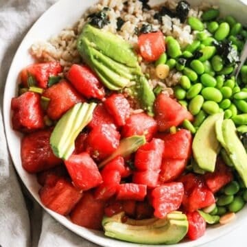 Vegan watermelon poke bowl with edamame, rice, and avocado.