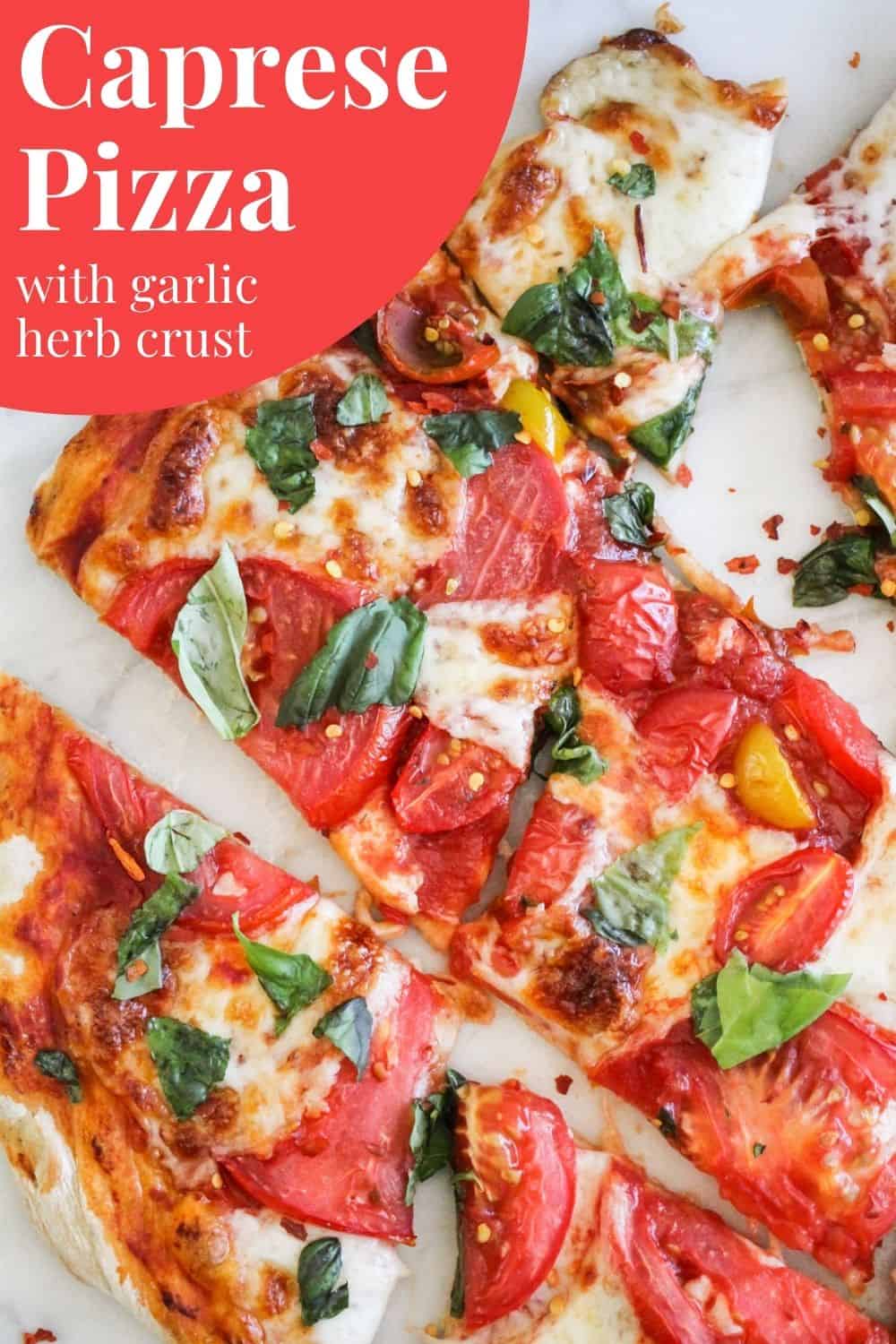 Pizza topped with tomatoes and basil with red and white text reading, "Caprese Pizza with Garlic Herb Crust."