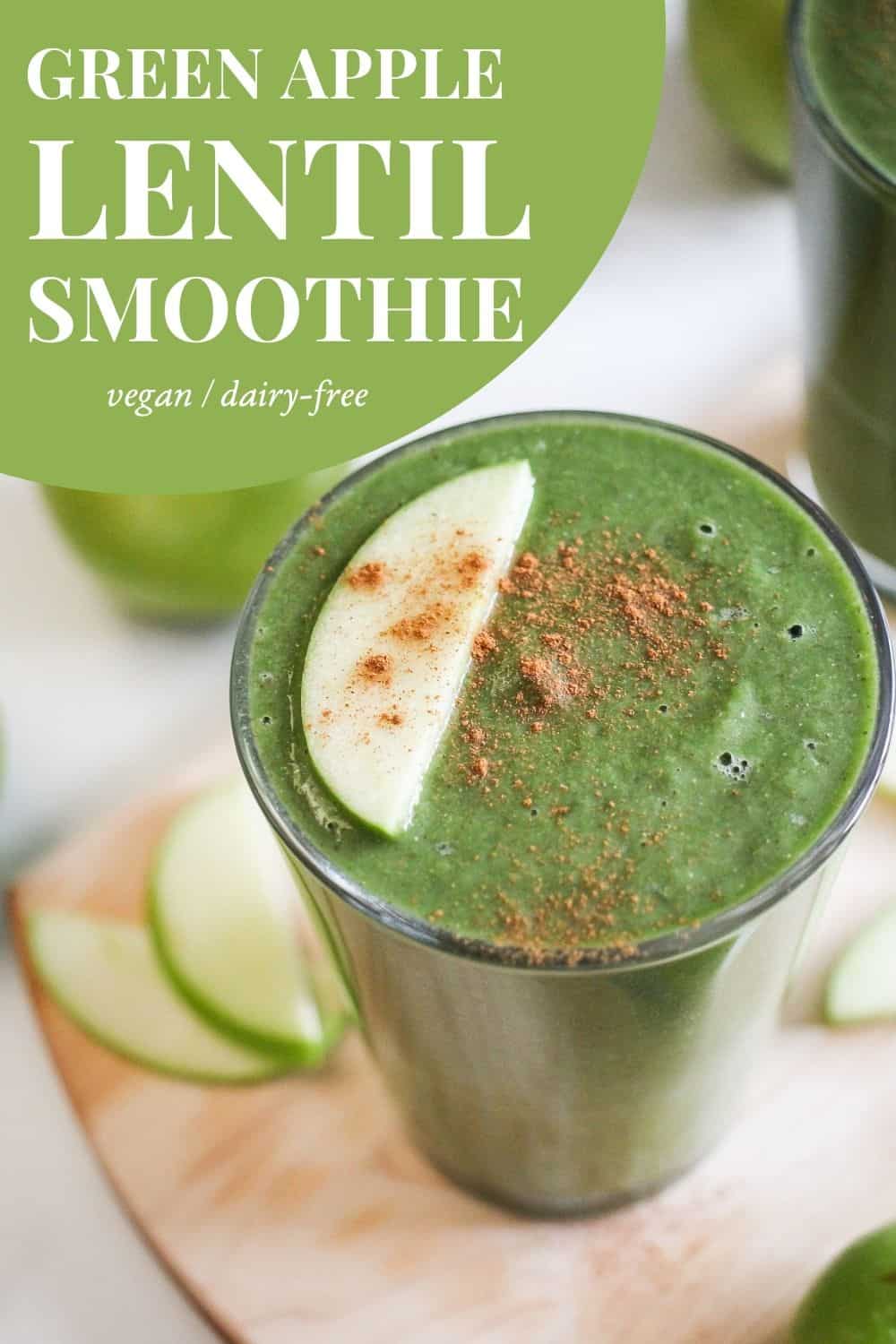 Green smoothie topped with cinnamon and apple slice with green and white text reading, "Green Apple Lentil Smoothie: vegan, dairy-free."