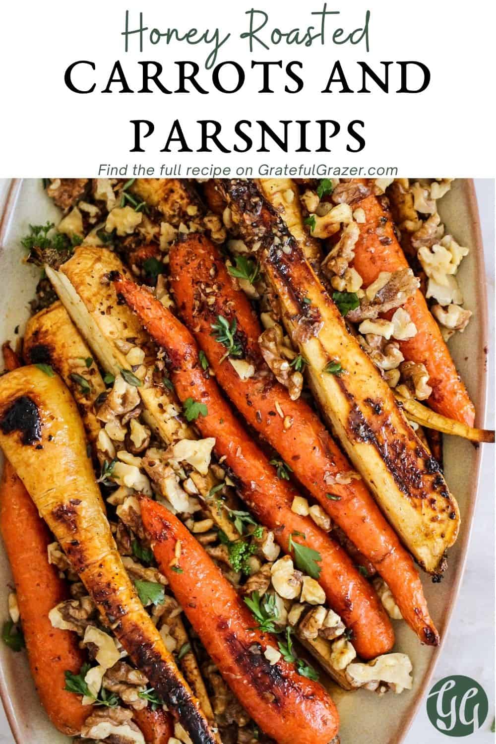 Roasted vegetables with nuts and parsley on beige ceramic platter with text reading, "Honey Roasted Carrots and Parsnips - find the full recipe on GratefulGrazer.com."