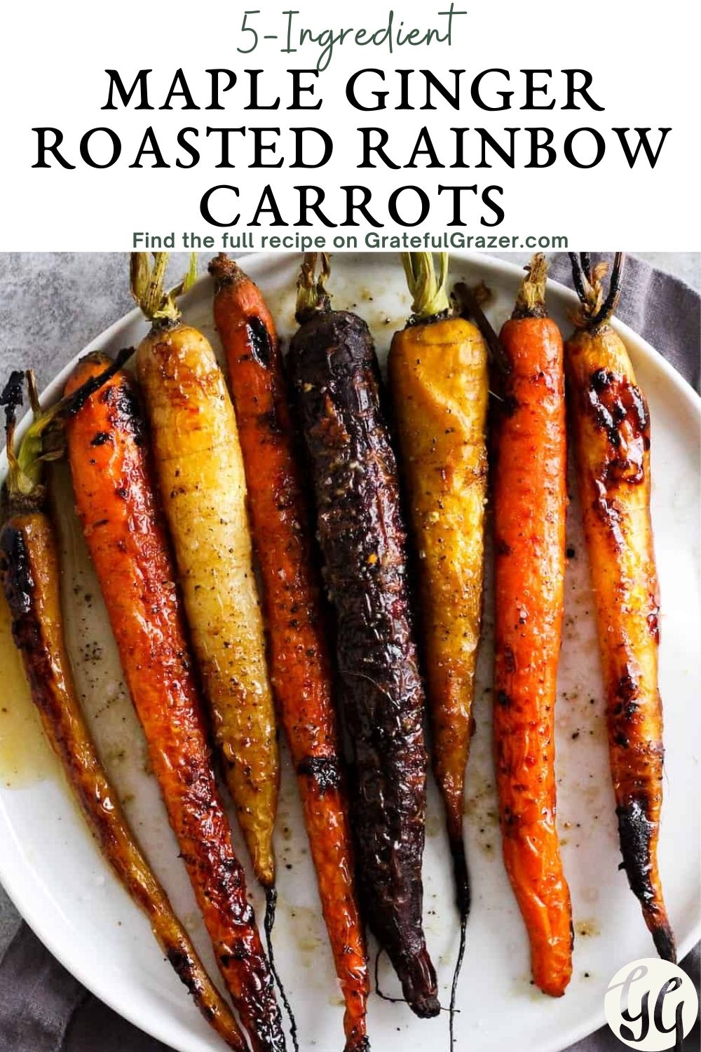Roasted rainbow carrots on a white plate with text reading, "5-Ingredient Maple Ginger Roasted Rainbow Carrots. Find the full recipe on GratefulGrazer.com"