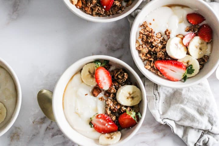 Overhead horizontal image of vegan granola bowls with fruit.