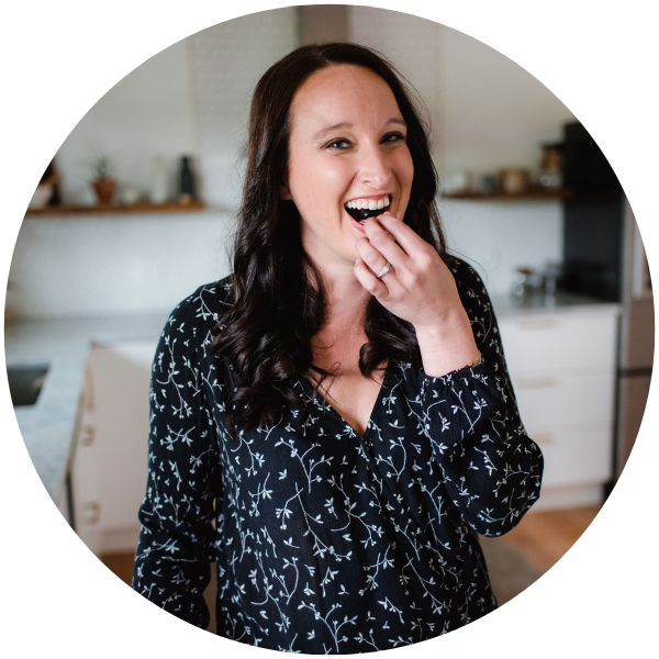 Stephanie McKercher, eating and smiling in a kitchen.