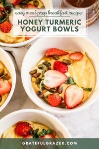 Yellow turmeric yogurt bowls topped with strawberries and pistachios with text reading. "Easy Meal Prep Breakfast Recipe: Honey Turmeric Yogurt Bowls; GratefulGrazer.com."