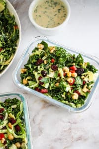 Meal Prep Salad in glass containers against white marble background.