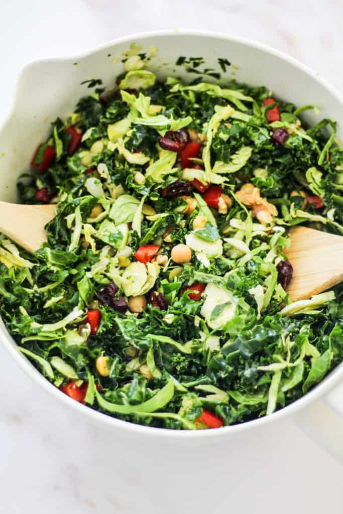 Closeup image of a meal prep kale salad in a large mixing bowl.