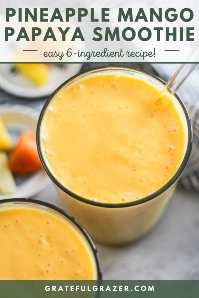 Orange smoothie in a glass with a glass straw and text that reads, "Pineapple Mango Papaya Smoothie: easy 6-ingredient recipe; GratefulGrazer.com."
