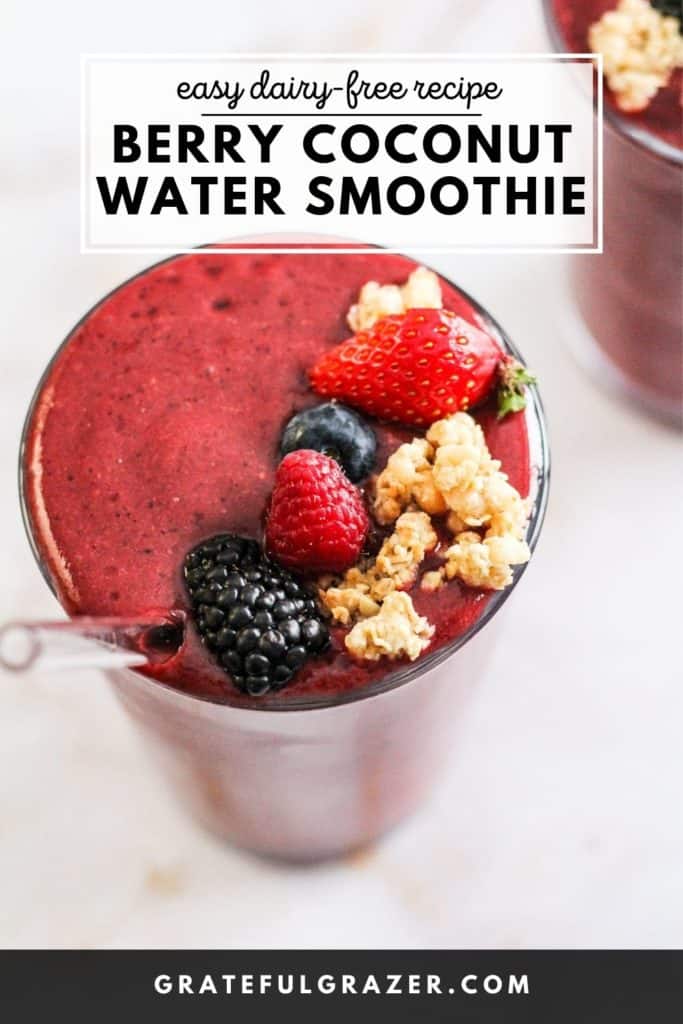 Red berry smoothie in a glass topped with fresh berries and granola. Text reads, "Easy Dairy-Free Recipe: Berry Coconut Water Smoothie; GratefulGrazer.com."