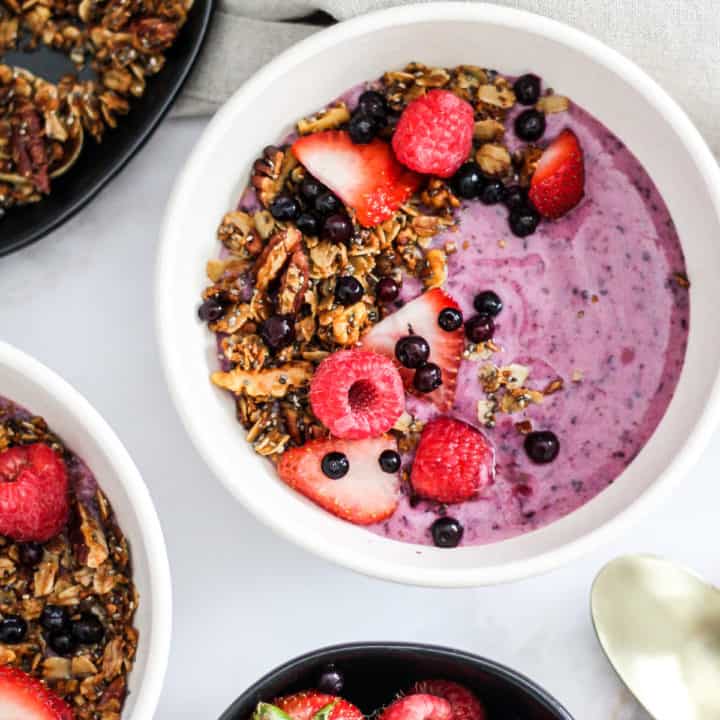 Overhead image of wild blueberry yogurt bowl with fresh berries and granola.
