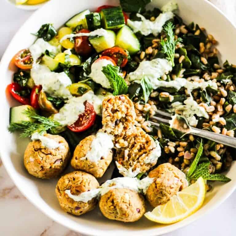 Greek falafel grain bowl with veggies and yogurt tzatziki sauce.