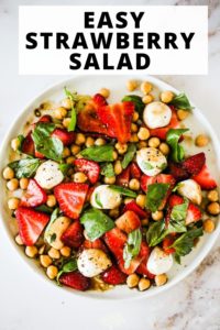 Overhead image of a Summer Strawberry Salad with mozzarella and chickpeas. Text reads, "Easy Strawberry Salad."