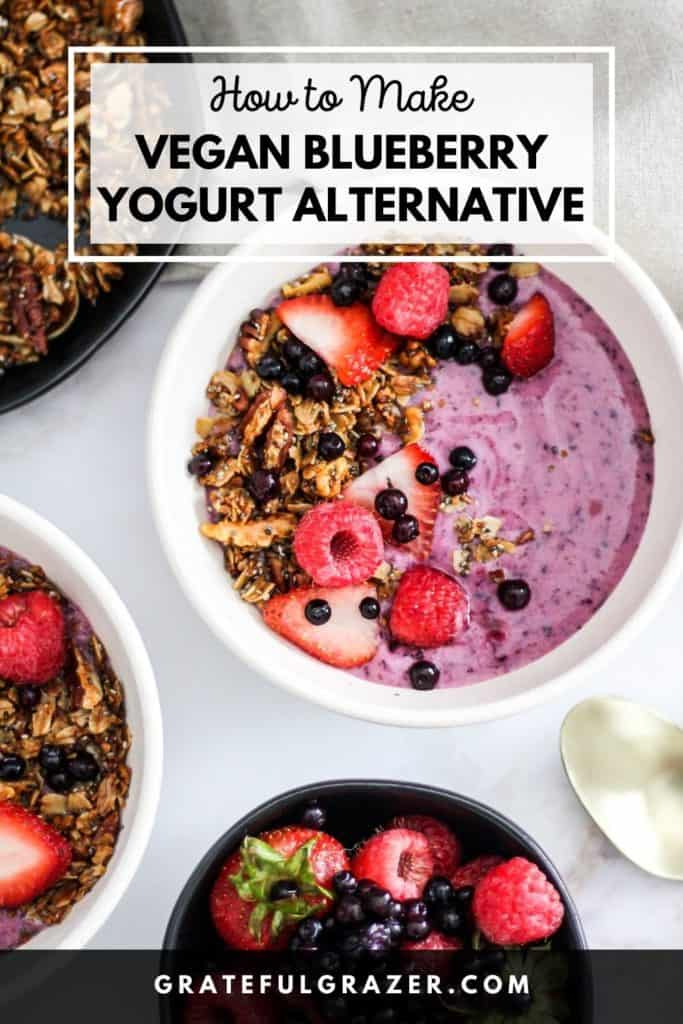 Blueberry yogurt bowl topped with berries and granola with text reading, "How to Make Vegan Blueberry Yogurt Alternative; GratefulGrazer.com."