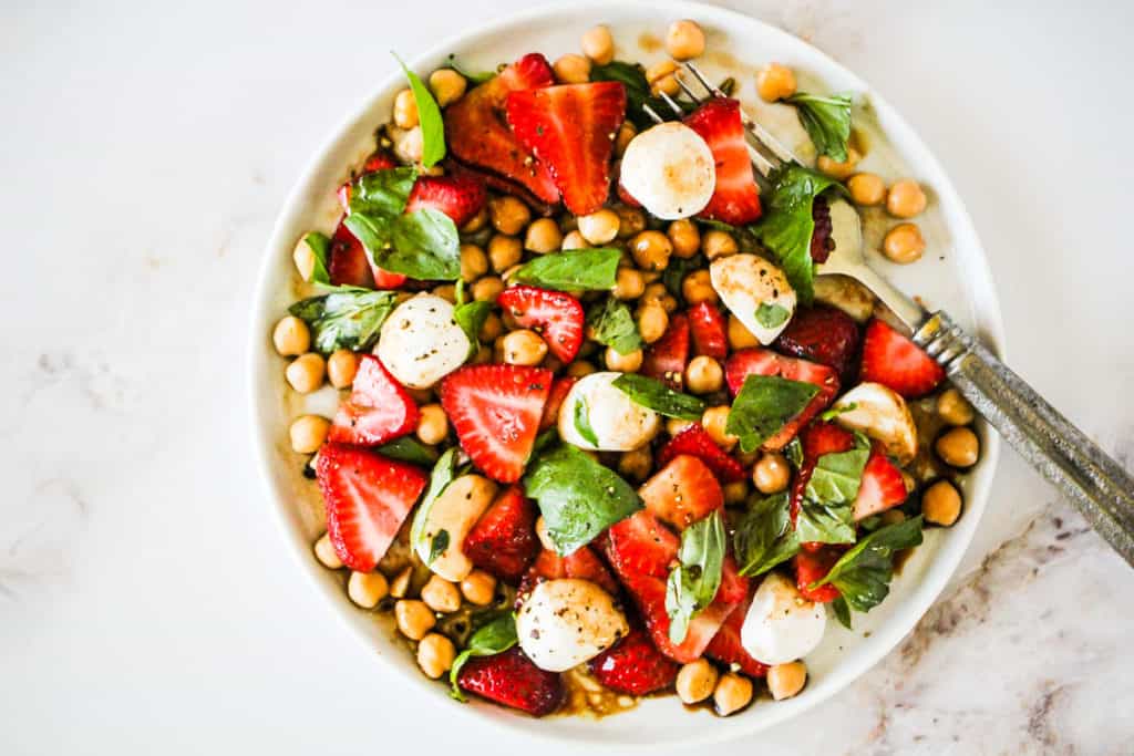 Horizontal image of a Summer Strawberry Salad on a white plate.