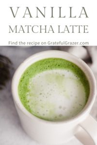 Matcha latte in a white mug with text that reads, "Vanilla Matcha Latte; find the recipe on GratefulGrazer.com."