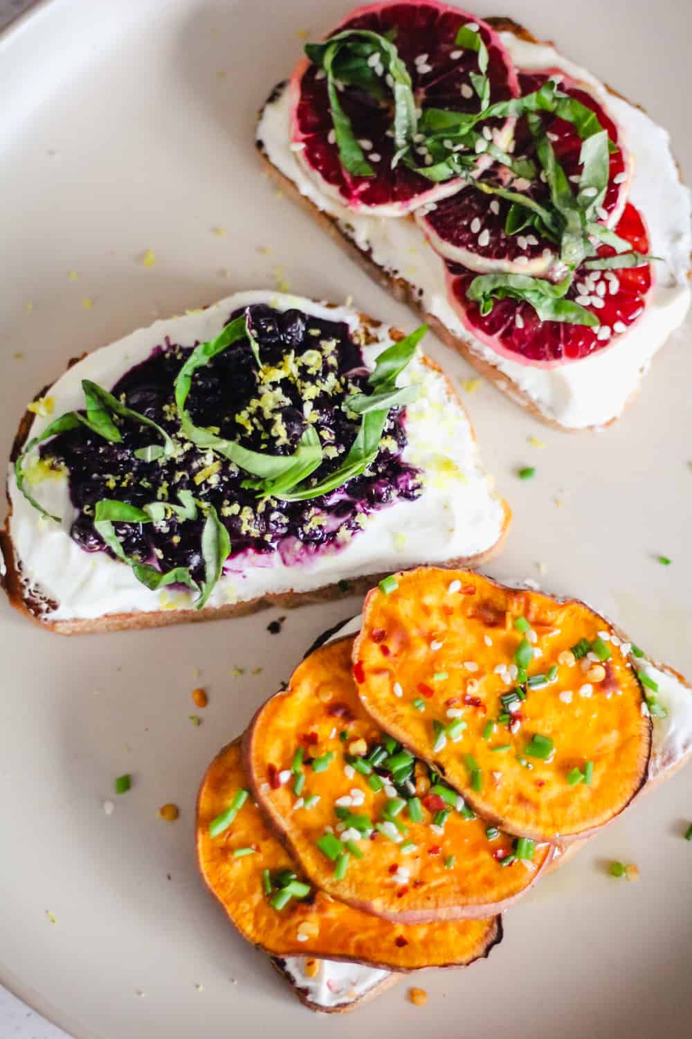 3 slices of toast topped with yogurt and sweet potato, wild blueberries, or blood oranges.