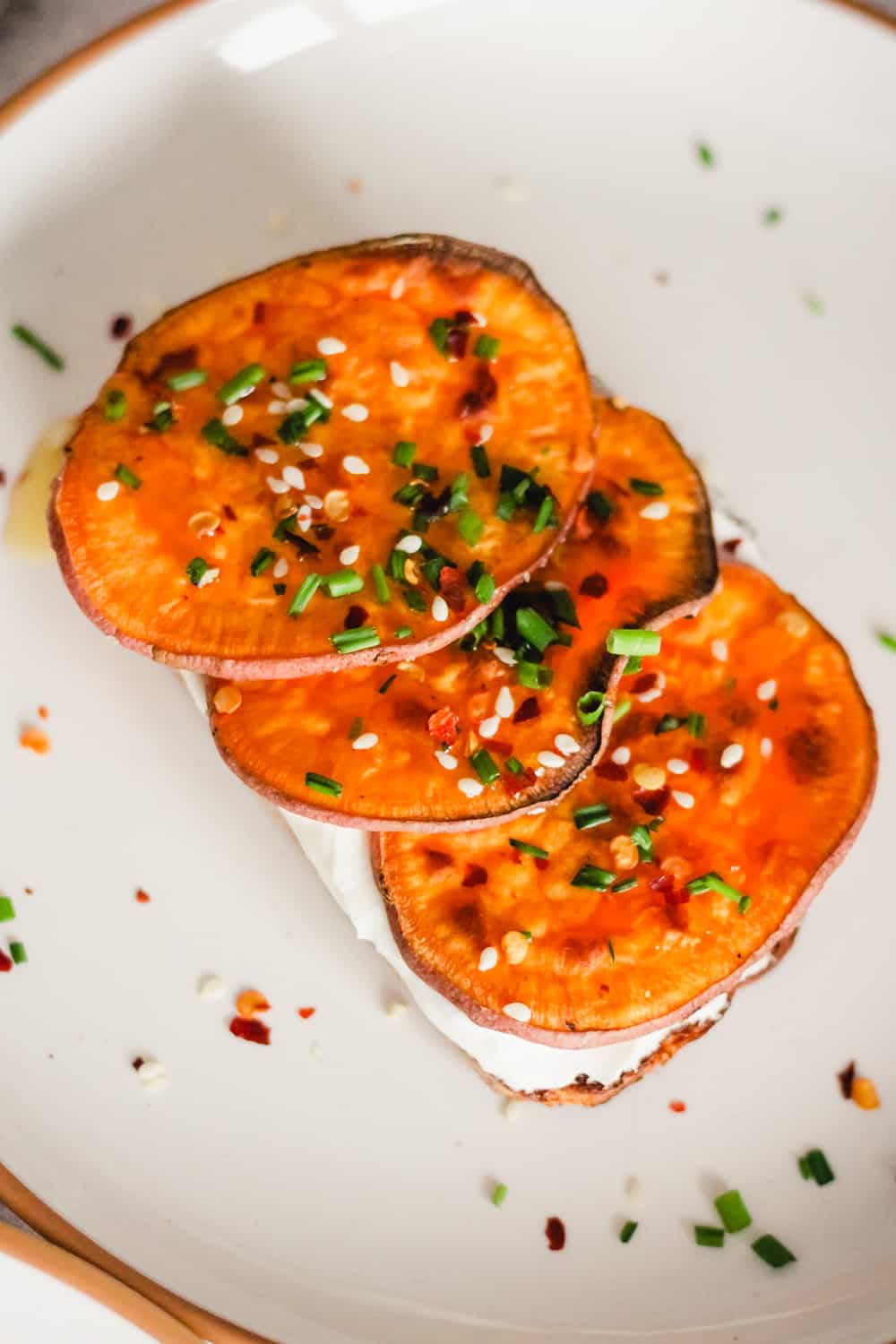 Toast topped with yogurt, sweet potato, chives, and sesame seeds.