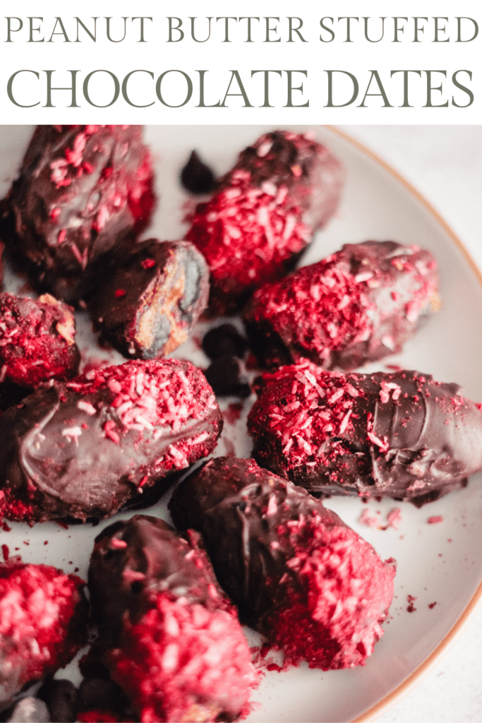 Chocolate Covered Dates with raspberry and coconut topping on a white plate. Text reads, "Peanut Butter Stuffed Chocolate Dates."