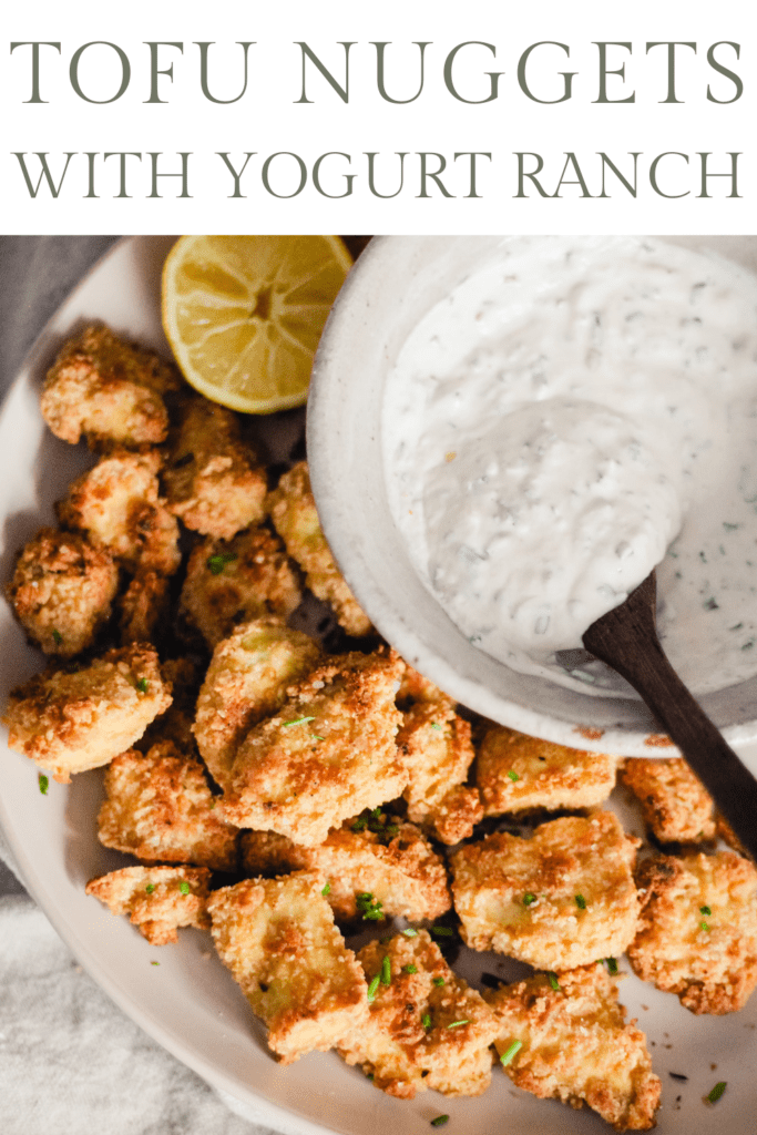 Crispy tofu nuggets on a white plate with a bowl of yogurt ranch dip. Text reads, "Tofu Nuggets with Yogurt Ranch."