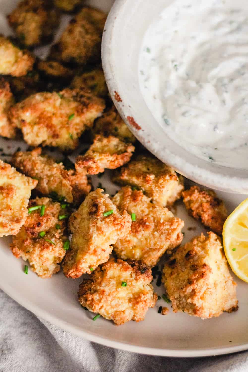 Crispy Tofu Nuggets on a plate with a bowl of yogurt ranch dip.