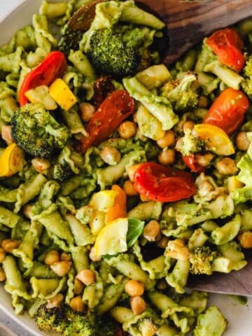 Vegetarian pasta with chickpeas, roasted veggies, and pesto sauce.