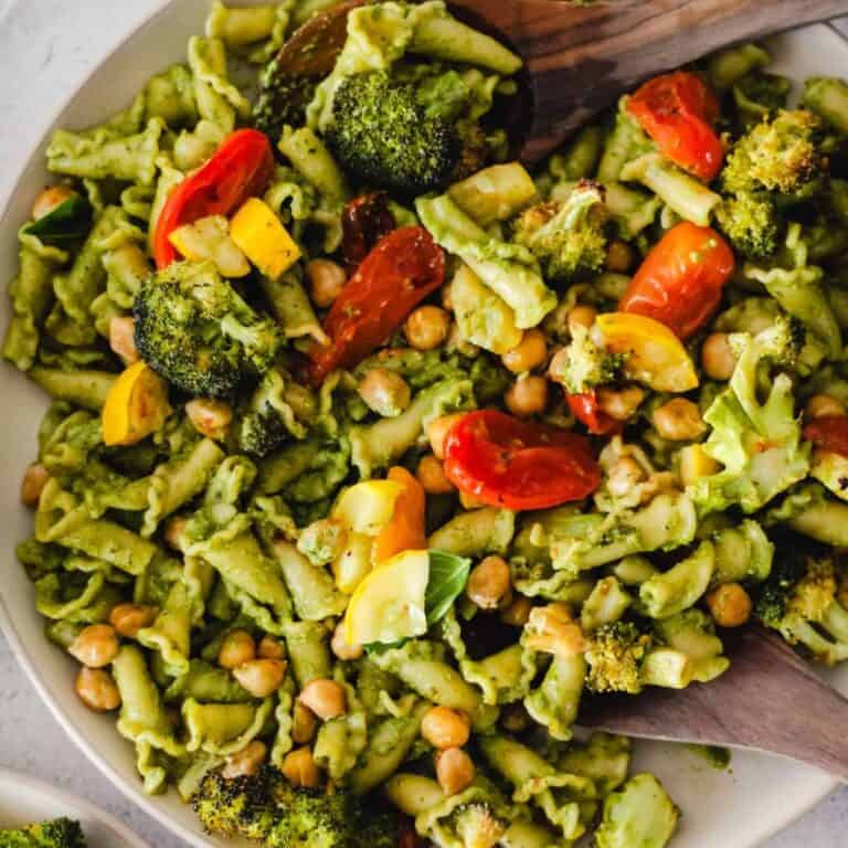 Vegetarian pasta with chickpeas, roasted veggies, and pesto sauce.