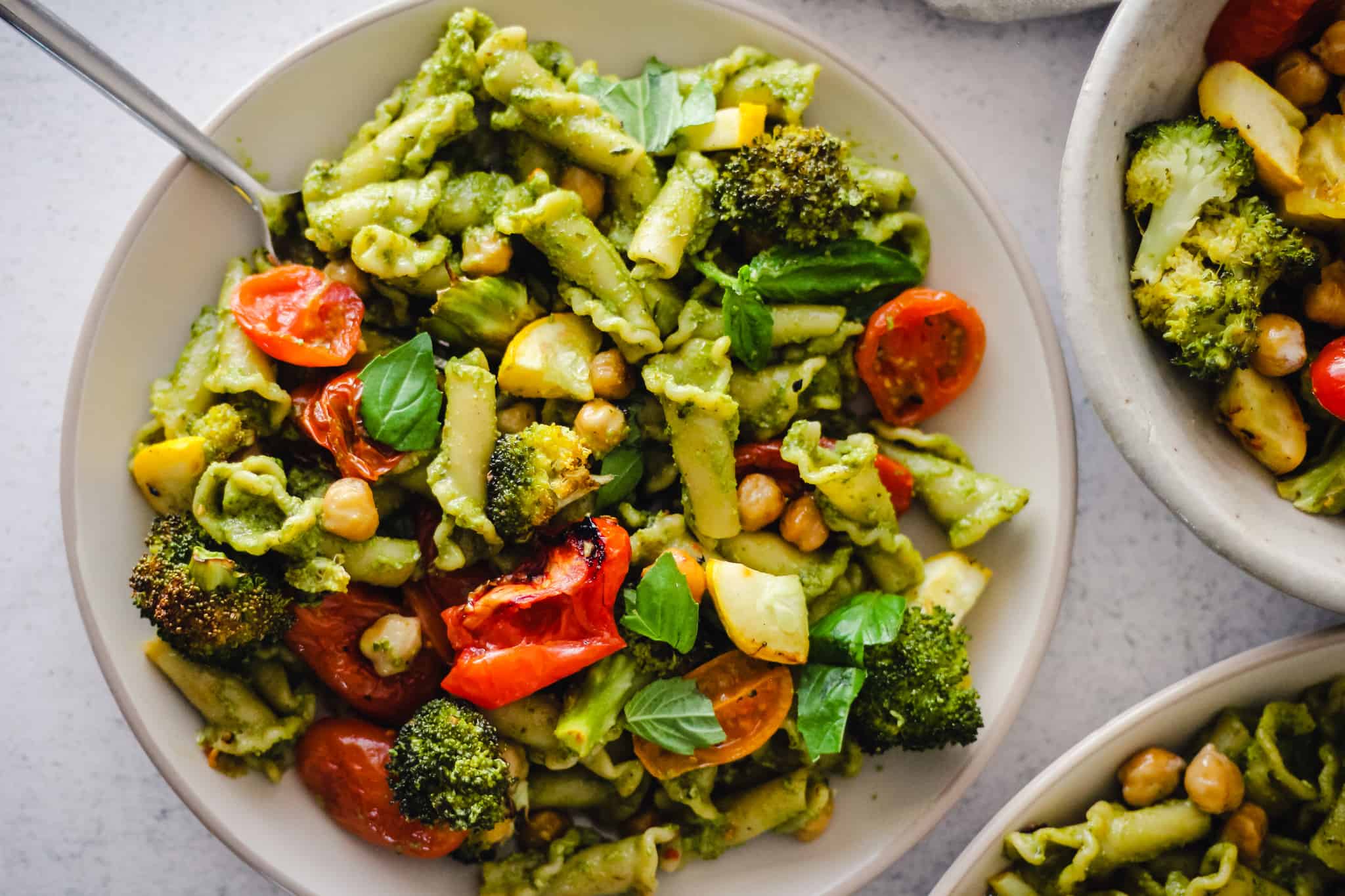 Horizontal image of pesto pasta on a plate.