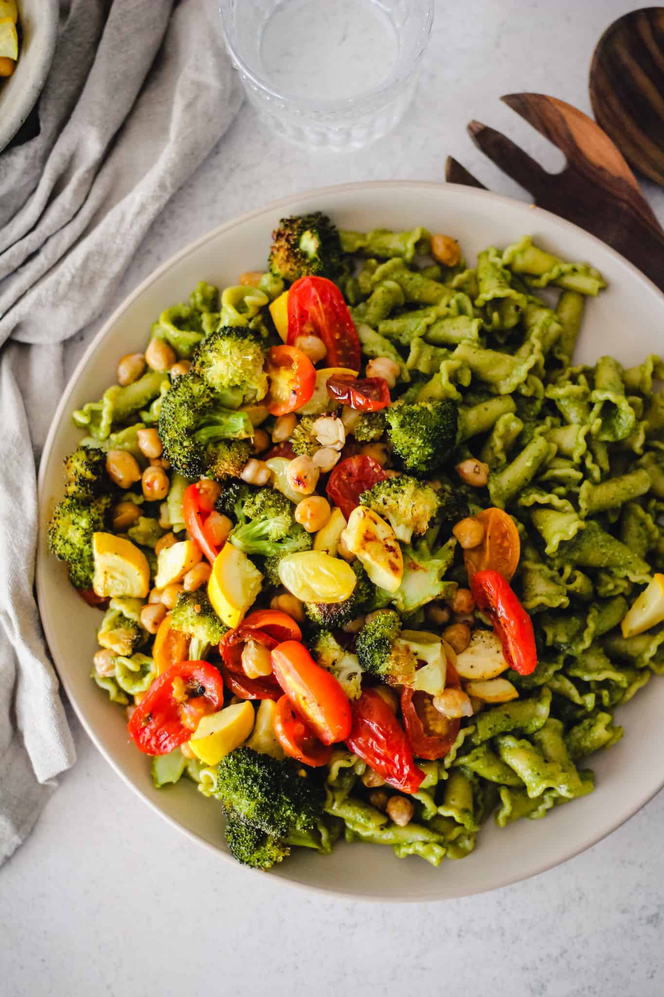 Plate of Veggie Pasta Pesto with a linen napkin.