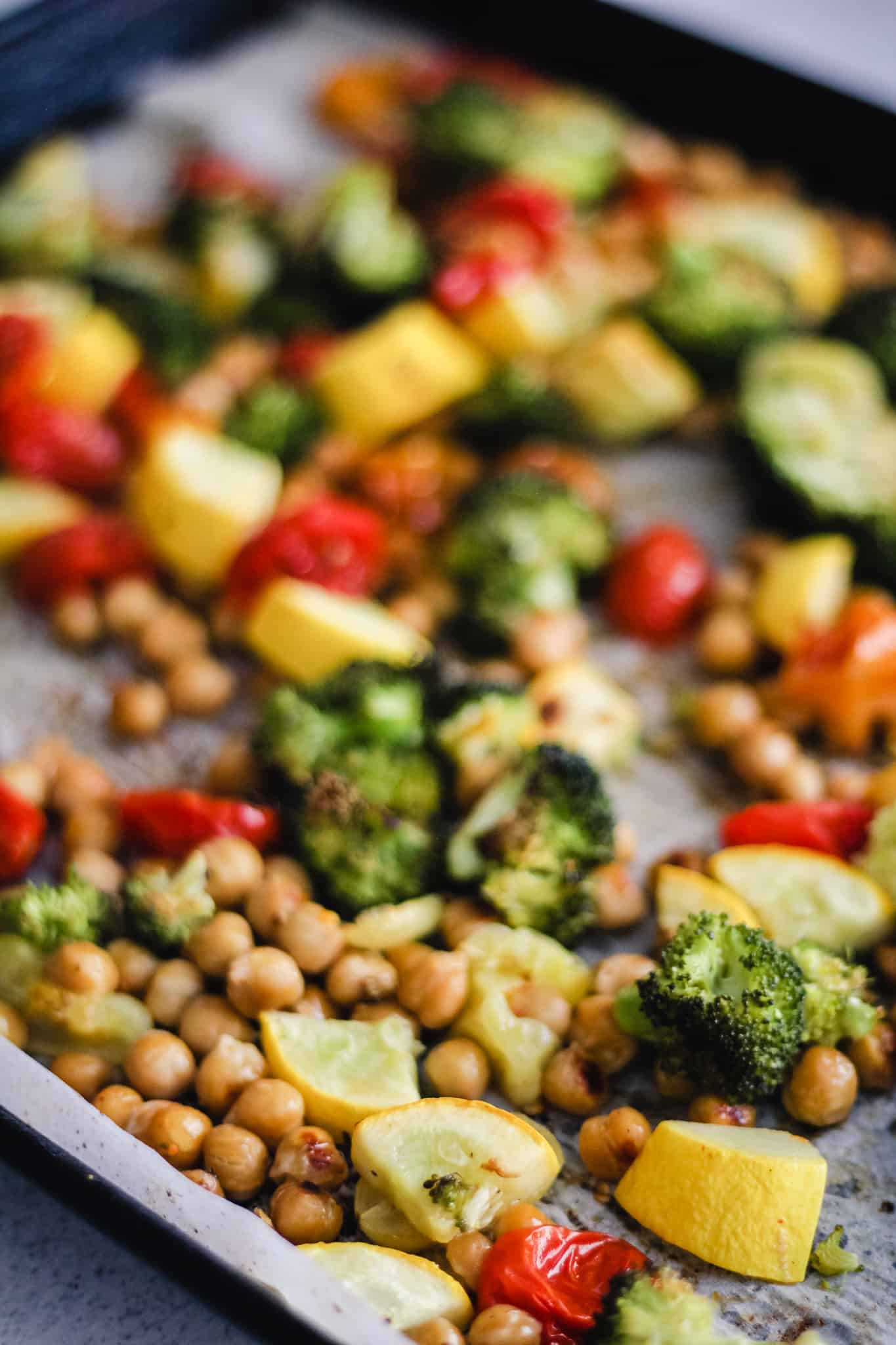 Roasted vegetables and chickpeas in a pan.