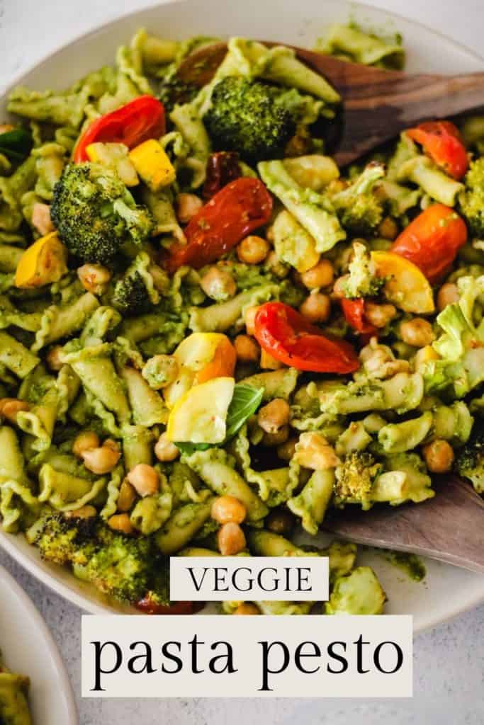 Pesto pasta with vegetables on a cream plate.  /text reads, 