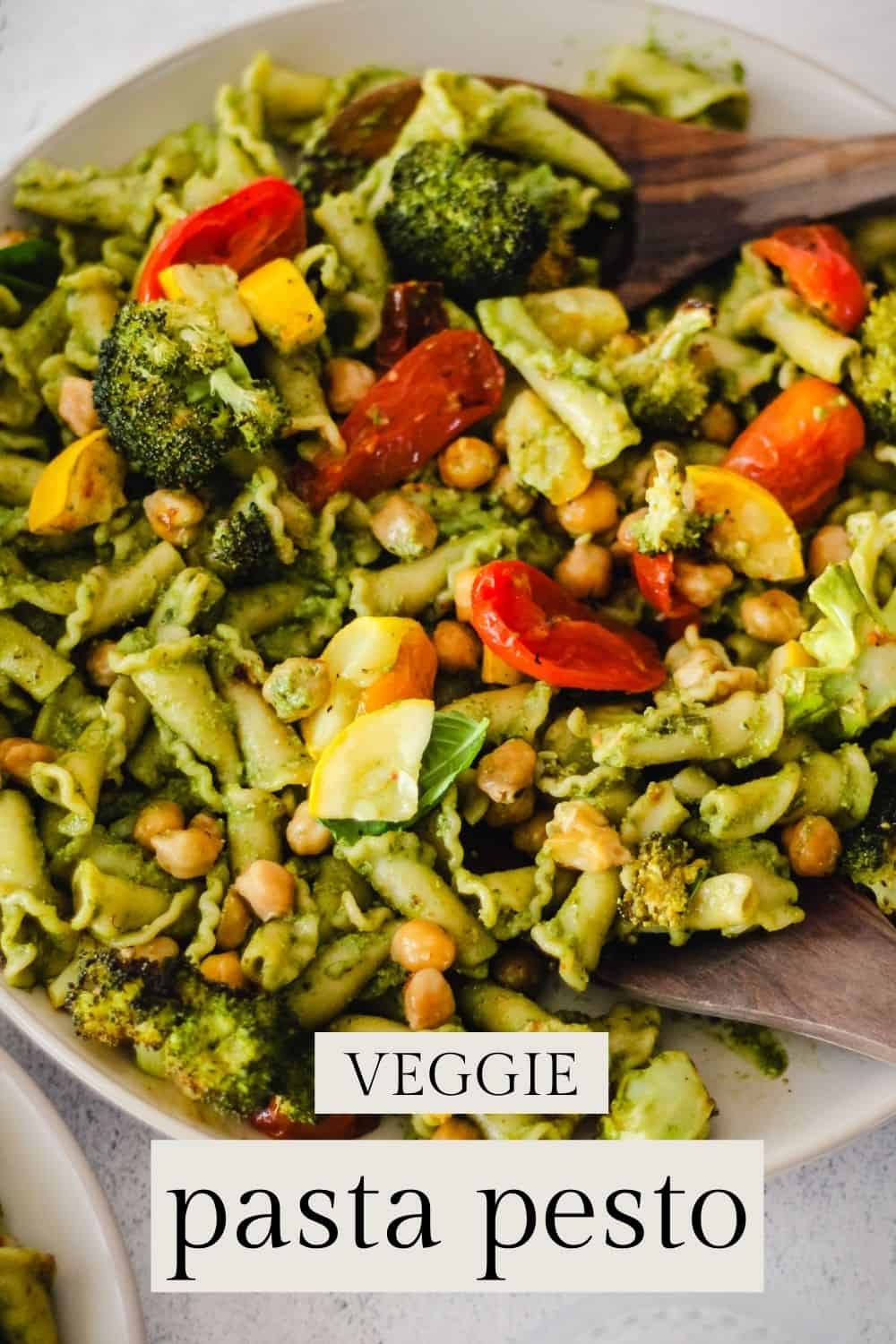 Pesto pasta with chickpeas, tomatoes, broccoli and yellow squash.  Text overlay reads, 