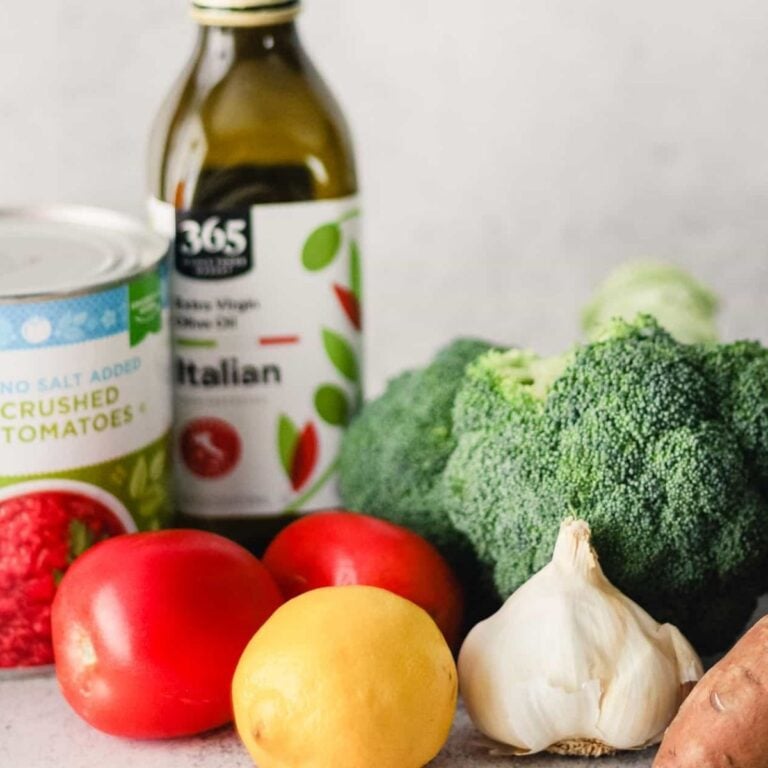 Vegetarian groceries, including olive oil tomatoes, and fresh vegetables.
