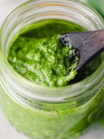 Walnut pesto sauce in a glass jar.