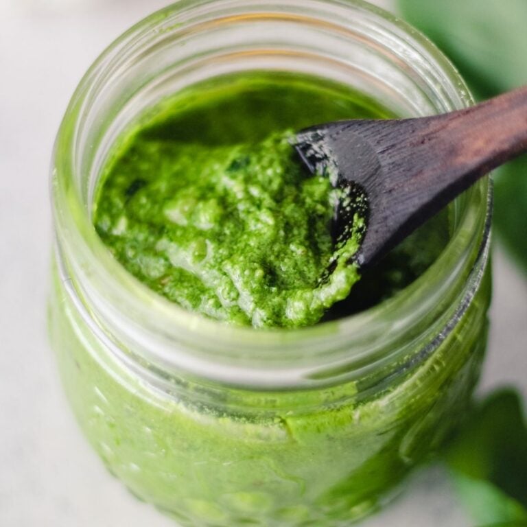Walnut pesto sauce in a glass jar.