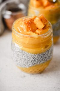 chia seed pudding in a jar with mango and banana.